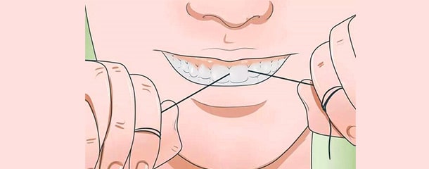 درمان تورم و قرمزی لثه با روش صحیح نخ دندان کشیدن